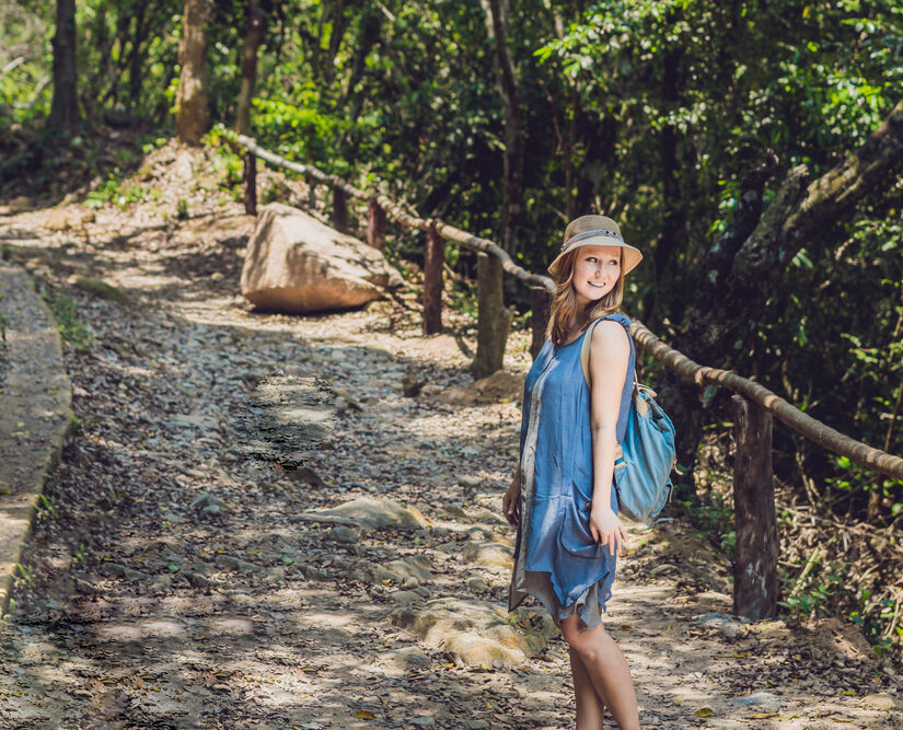 A,Young,Woman,Is,Standing,On,Forest,Road.